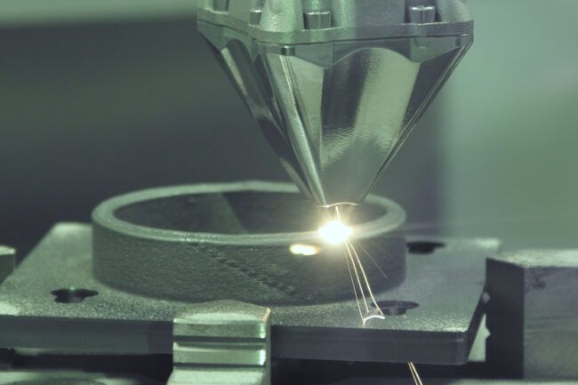 Industrial processing of titanium and aluminum alloys with inert chamber DED technology