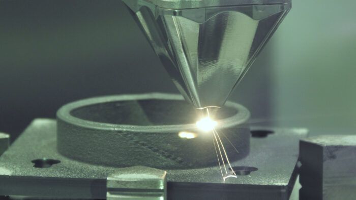 Industrial processing of titanium and aluminum alloys with inert chamber DED technology